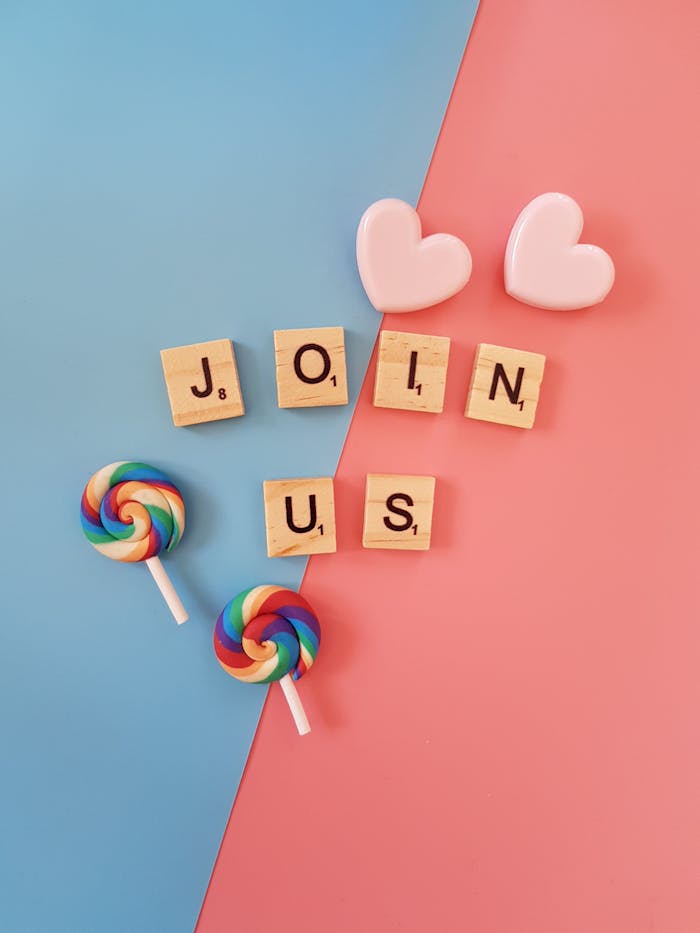 Bright Join Us call-to-action with colorful lollipops and hearts on a pastel background.